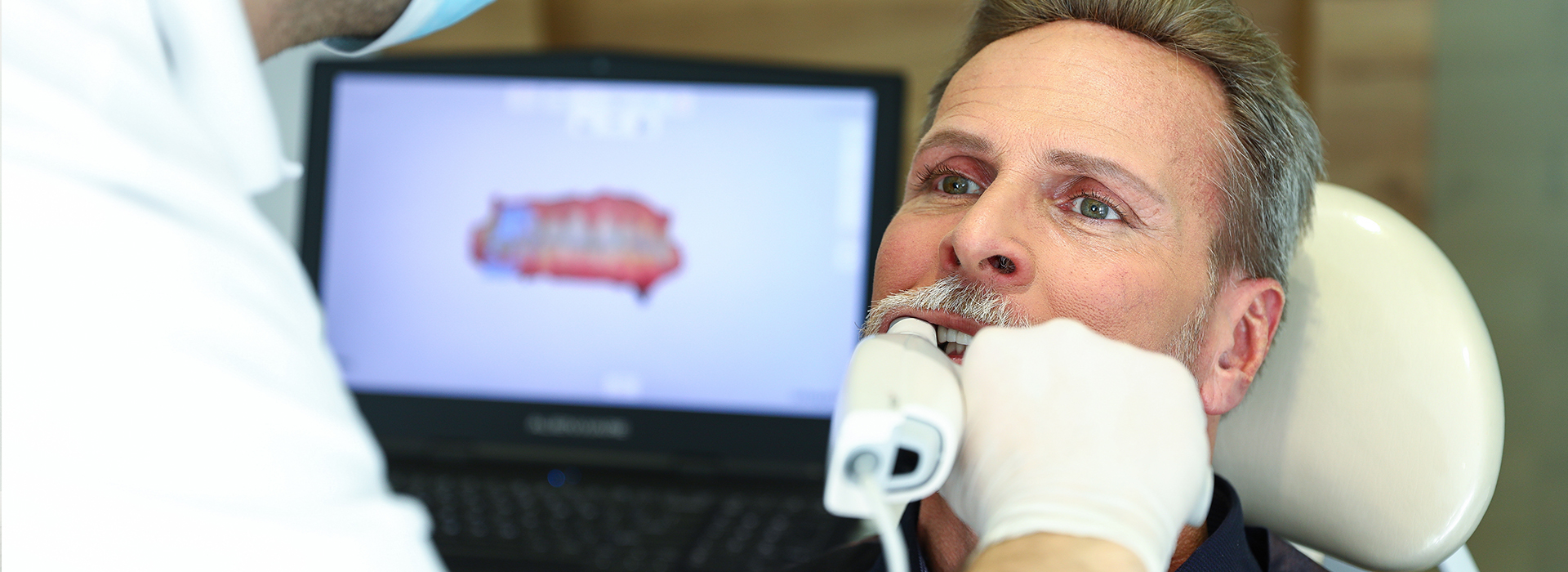 A person receiving dental care, with a dentist performing the procedure.