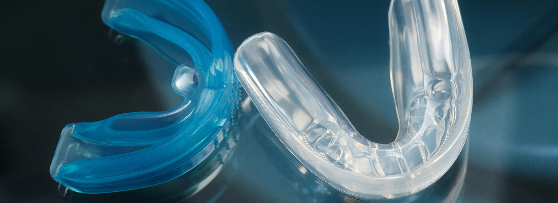 Transparent blue plastic toothbrush head on a clear background.